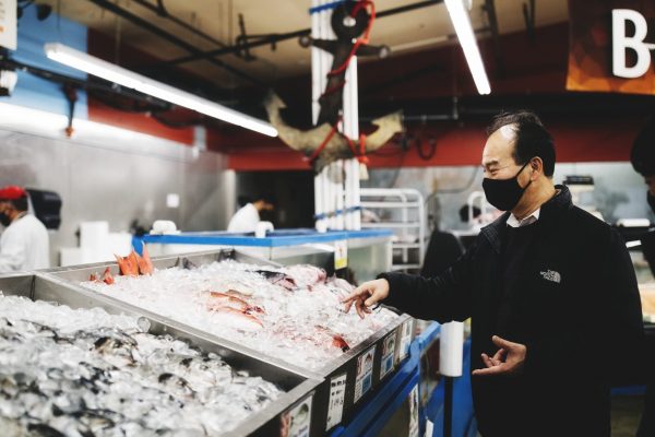 Renton fishmarket Man stands over fish at local supermarket in Renton, Washington.